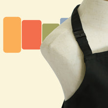 Load image into Gallery viewer, close up photo of safety breakaway clasp on neck of black apron