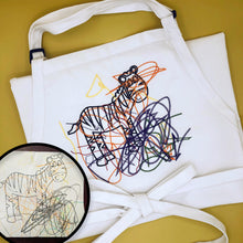 Load image into Gallery viewer, white chefs apron with custom embroidery of a keepsake children's doodle.  drawing is a coloring book page of a zebra with orange yellow purple and green crayon swirls
