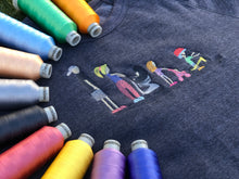 Load image into Gallery viewer, close up photo of embroidered family chalk drawing.  rainbow spools of thread surround the family
