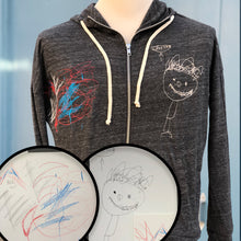 Load image into Gallery viewer, heather gray zip up hoodie with custom embroidery of blue and red abstract shapes on right chest and cream drawing of little boy on left chest
