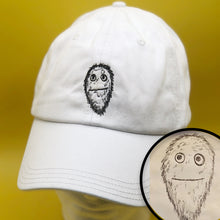 Load image into Gallery viewer, White baseball cap with custom embroidery of furry little face in black thread
